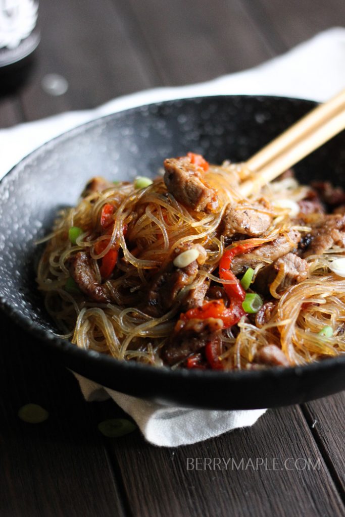 a bowl of clear noodles pork stir fry 