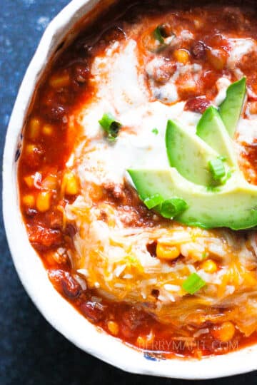 delicious instant pot chili with avocado and sour cream on top