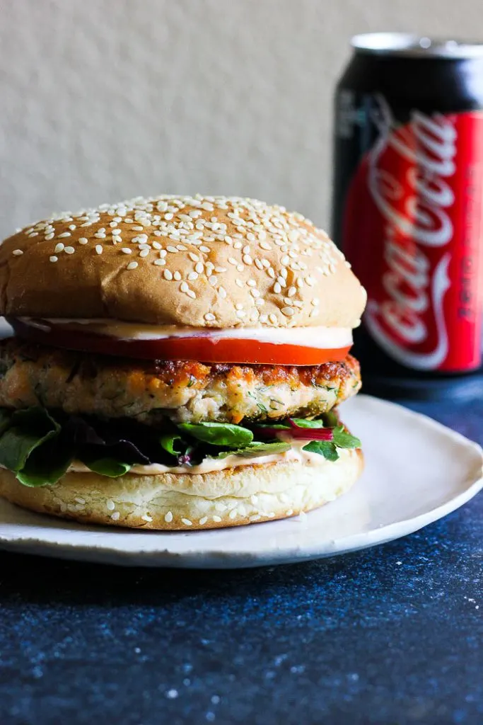  Juicy aromatic salmon dill burger paired with spicy lime infused refreshing aioli and crunchy sweet potato fries with creamy avocado dipping sauce