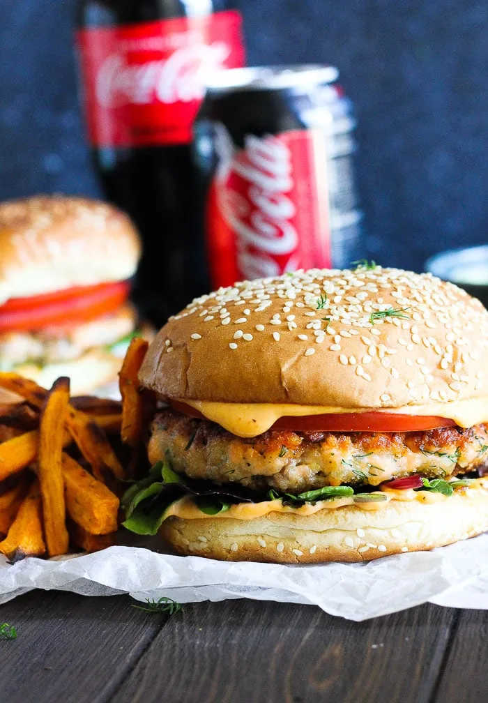 Juicy aromatic salmon dill burger paired with spicy lime infused refreshing aioli and crunchy sweet potato fries with creamy avocado dipping sauce.