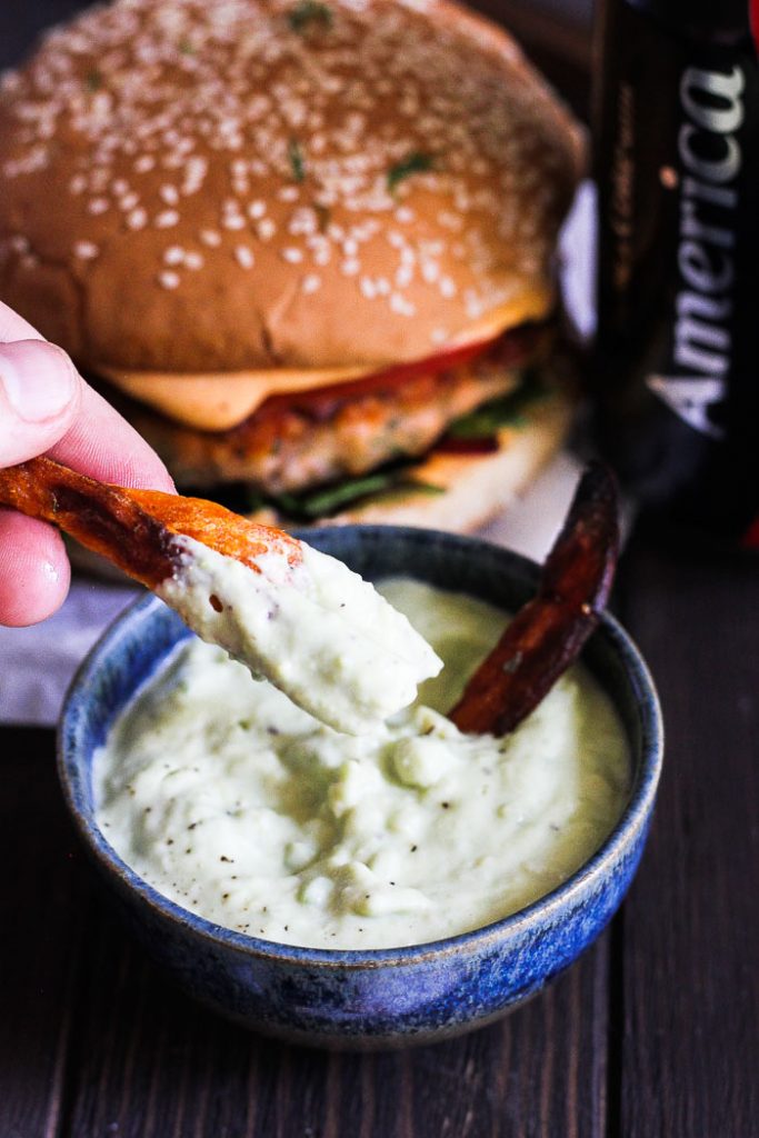 Juicy aromatic salmon dill burger paired with spicy lime infused refreshing aioli and crunchy sweet potato fries with creamy avocado dipping sauce.
