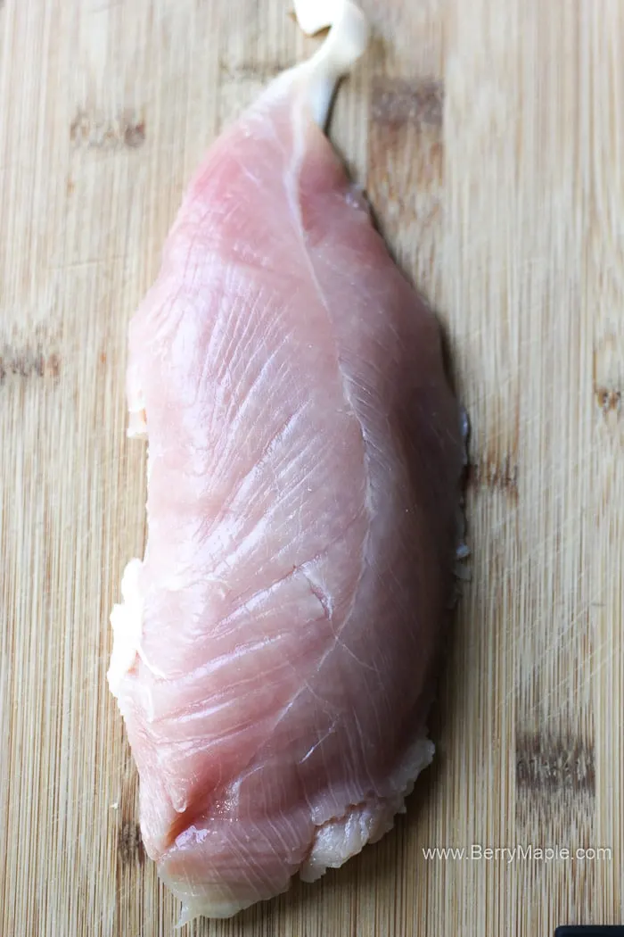 raw poultry on the brown cutting board