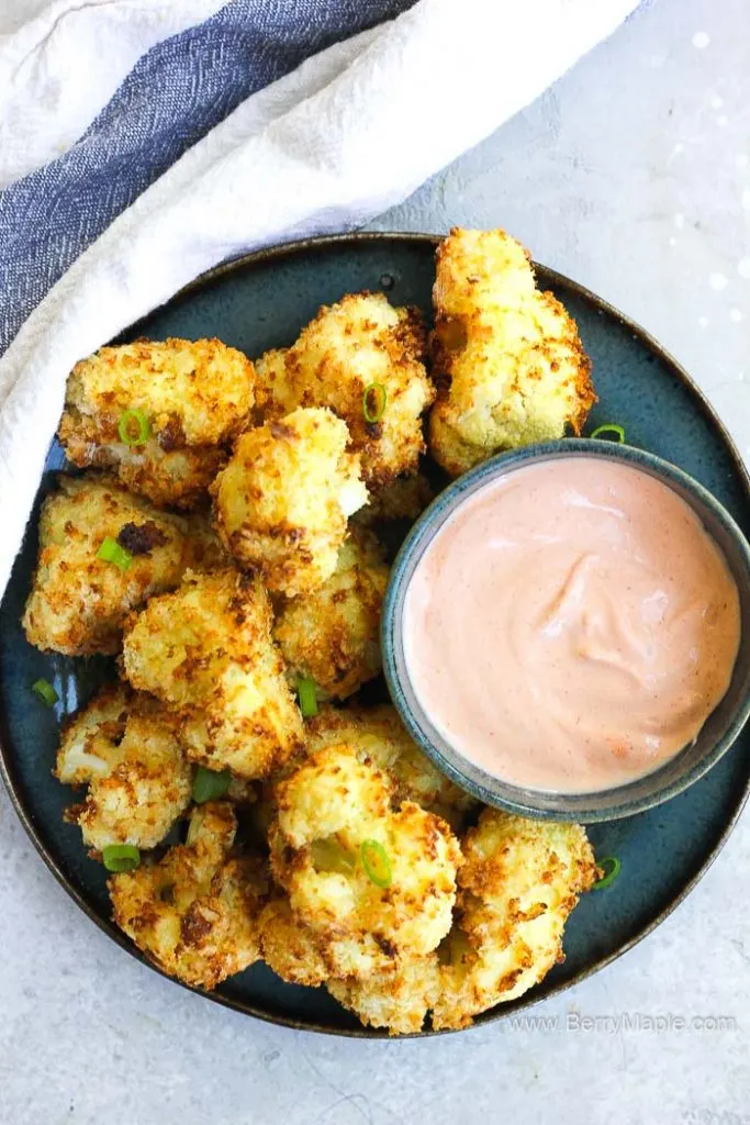 air fryer cauliflower with a bowl of dip sauce