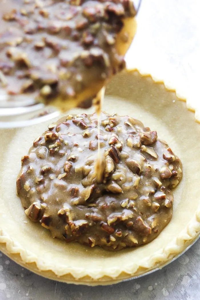 This classic delicious easy homemade pecan pie recipe will bring you the best flavor! With flaky crust and no corn syrup added, this traditional pie is great for your holiday celebrations- Thanksgiving, Christmas or for your weekend dinner dessert!