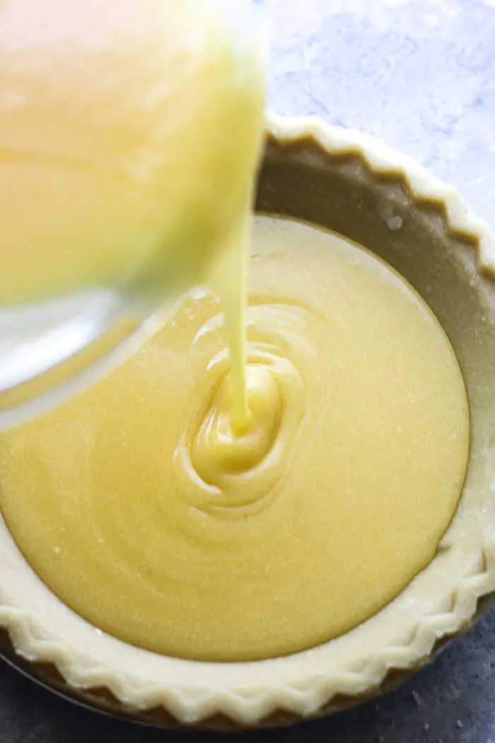 pouring chess pie batter into the pie shell