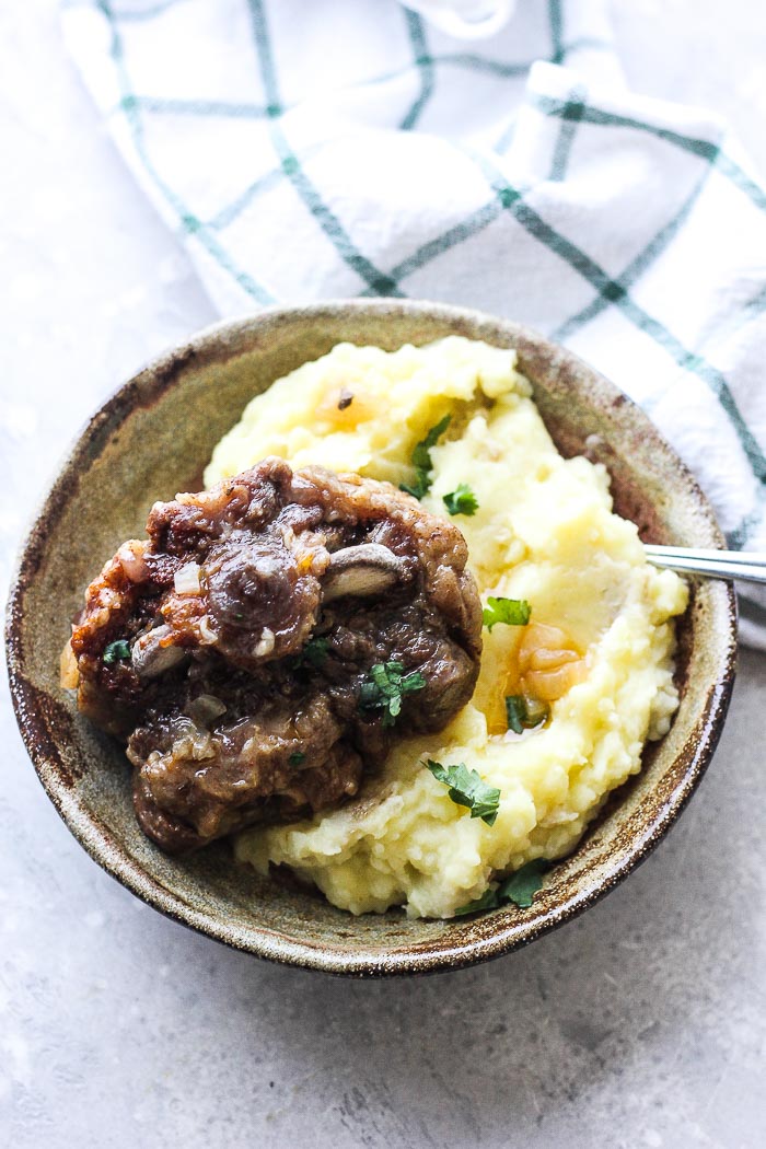 oxtails with mashed potatoes on the plate