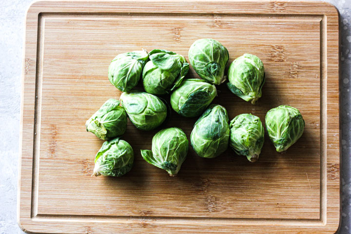 raw brussels sprouts on a cutting board
