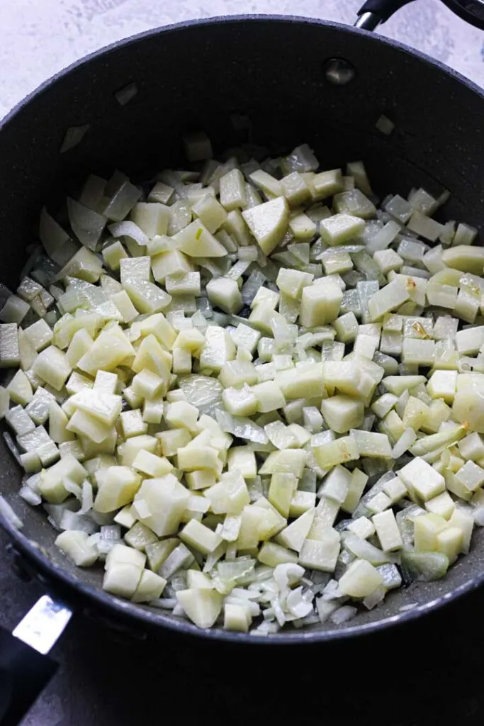 onions and raw potatoes in the pan