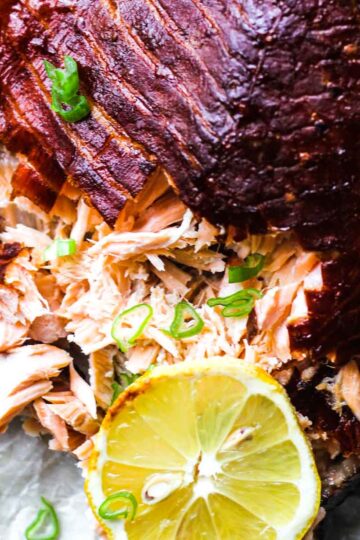 feature image of flaked smoked salmon fillet covered with lemon slices and chopped scallions
