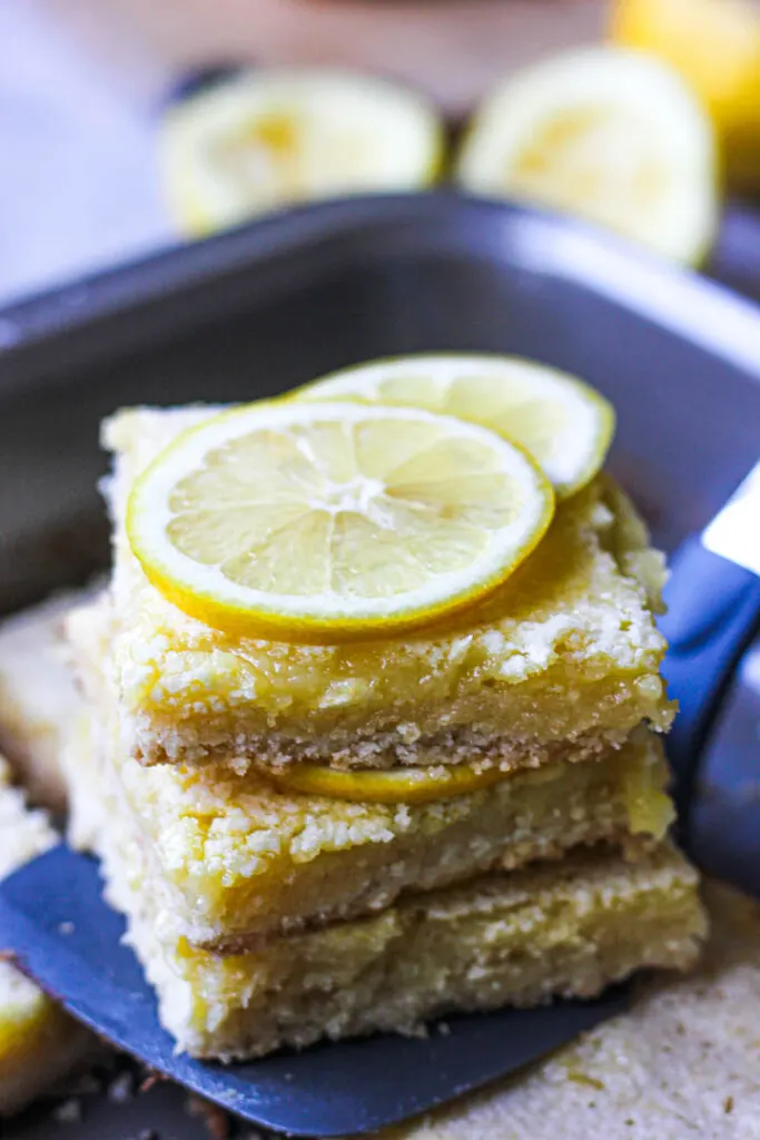 a stack of lemon bars with lemon slices on top