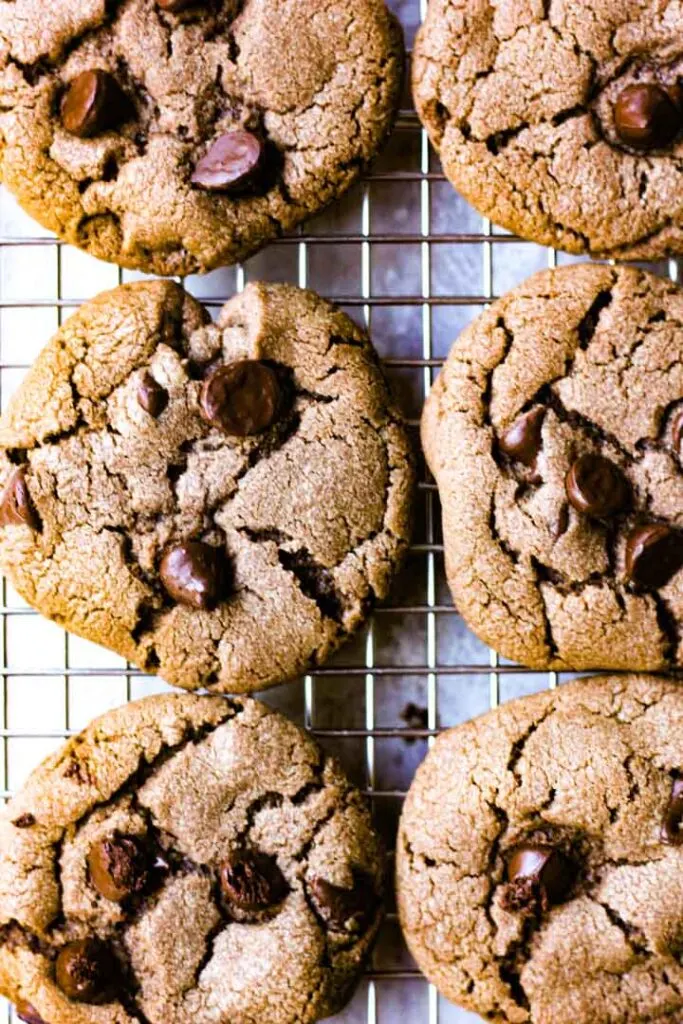 six chocolate cookies on a cooling rack