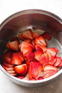 fresh sliced strawberries in a small pot