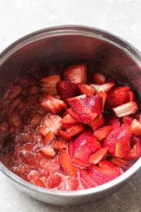 picture of simmered strawberry with some fresh berries on top