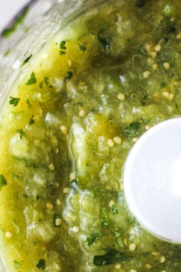 square image of green salsa inside the blender bowl