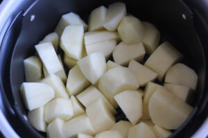 cut raw potatoes in the pot