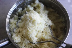 grated parmesan cheese in the mashed potato pot, process shot