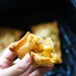 fried mini apple pie in hand