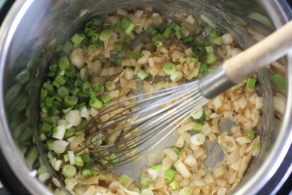 onions and green onions cooking in the pot