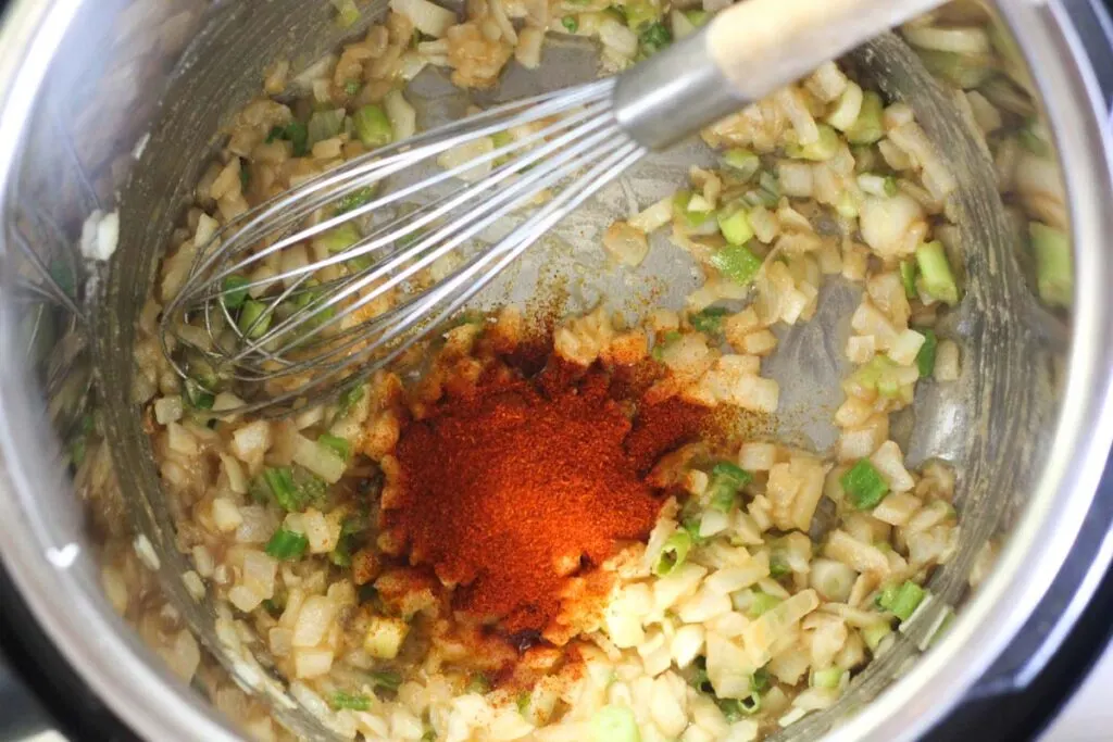 paprika and onions frying in the pressure cooker pot