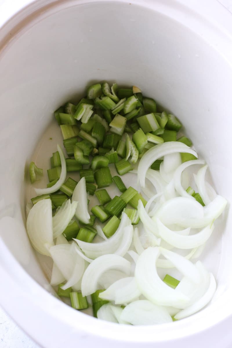 sliced onions and chopped celery in the pot