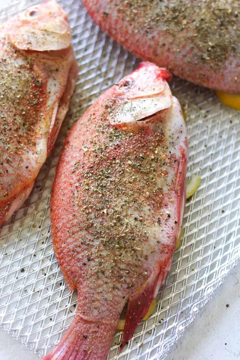 whole seasoned fish with lemon