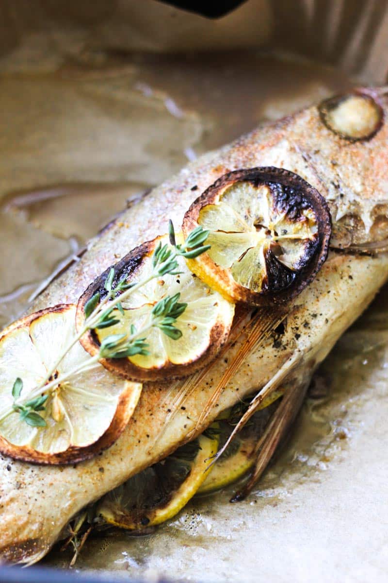 air fryer whole fish with lemon and herbs, top view