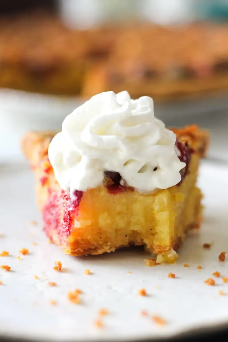 a slice of chess pie with cranberries on the plate