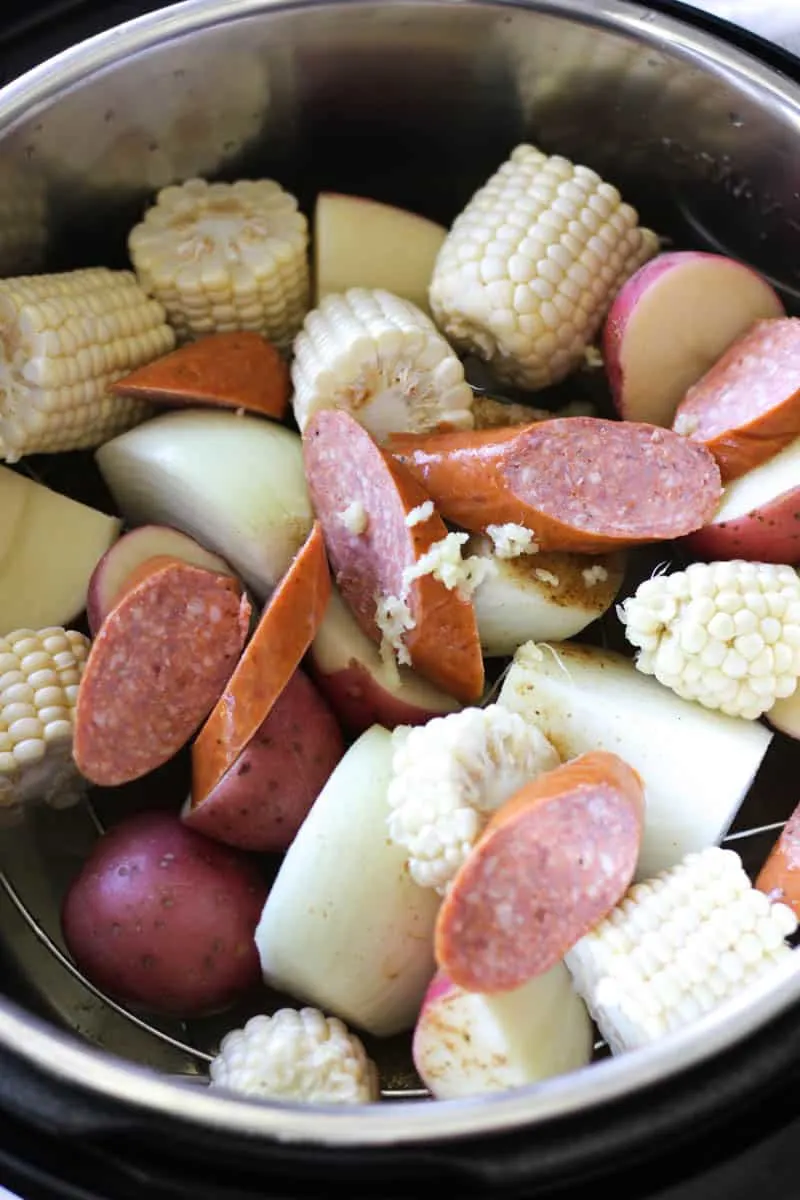 crab and shrimp and potatoes and corn in the pot