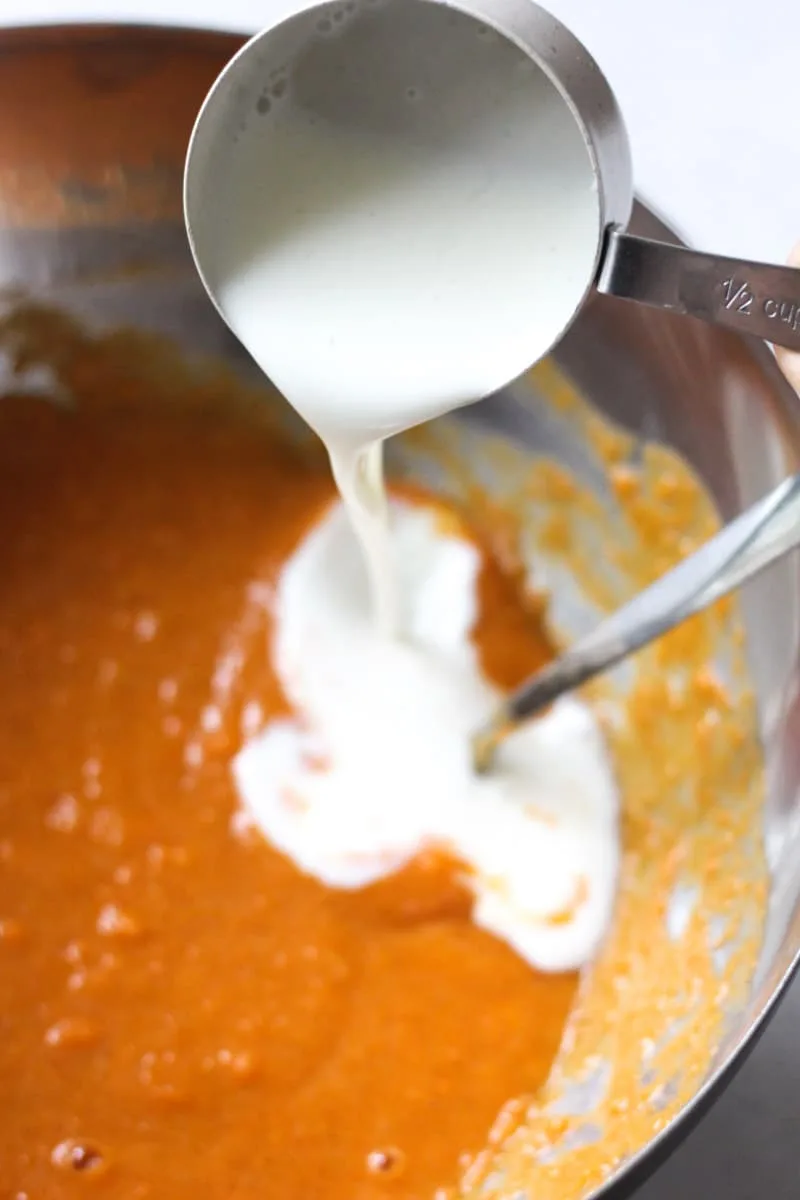 pouring buttermilk on top of pie batter