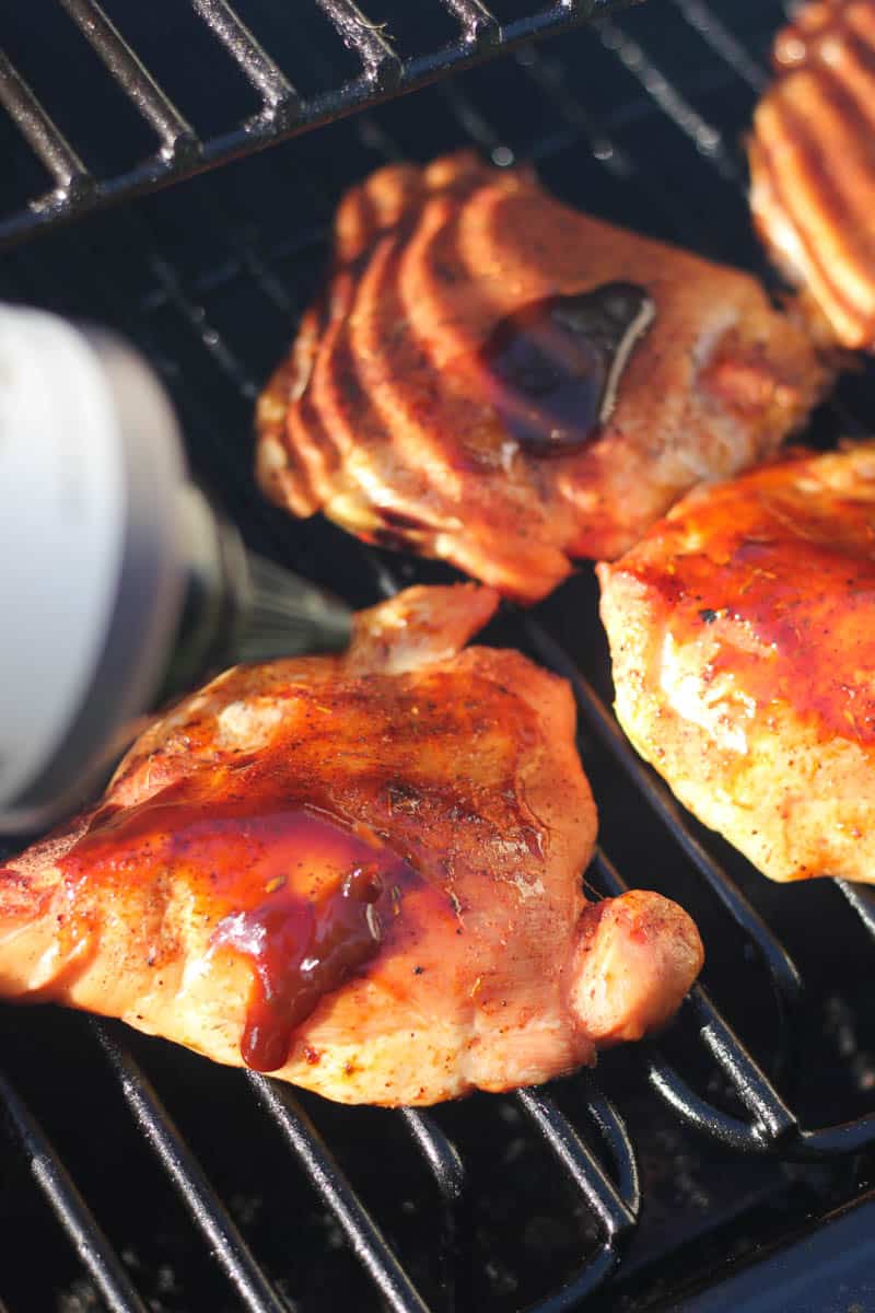 adding bbq sauce to chicken thighs