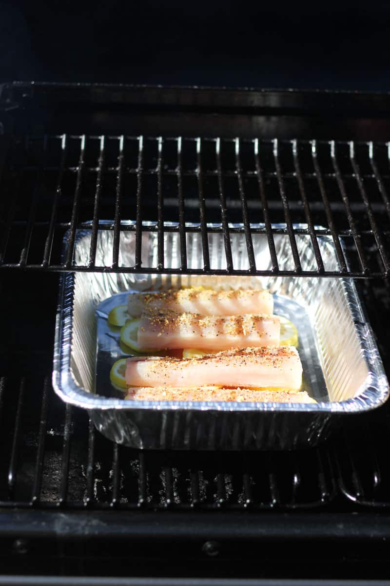 smoking raw mahi mahi in tin foil tray in the smoker