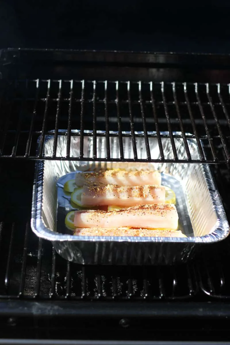smoking raw mahi mahi in tin foil tray in the smoker
